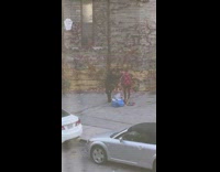 Shirtless guy poses grey house ivy window
