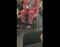 Guy holds frame of Obama on train 