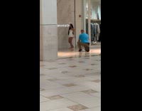 Woman white bunny outfit poses at storefront