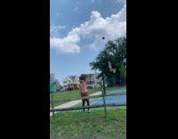 Guy jumps over fence shoots the ball