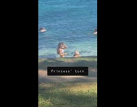 Old man takes video woman beach