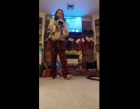 Girl carries cat from floor to walk