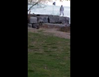 Guy white shirt flash umbrella shore park