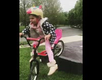 Little girl falls bicycle ramp yellow helmet