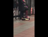 Little girl pink scarf lays on floor and cries at moms feet at subway station