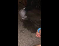 People walking by at music festival tripping on small ledge in floor