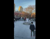 Person in middle of fountain with stick 
