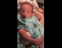 Baby boy blue sleeves raise arm fart