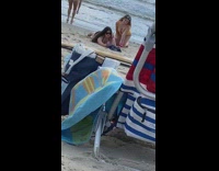 Two girls bikini kneel sand selfie chair 