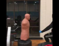 Guy fights punching mannequin dummy inside gym