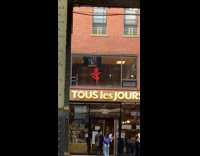 Guy dances near window above shop