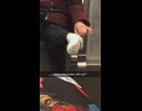 Woman takes off shoe and sock then picks her foot on subway train