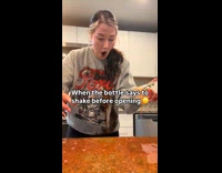 Woman shakes bottle breaks