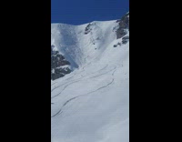 Guy skis down steep mountain 