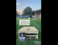 Girl plays corn hole makes all bags