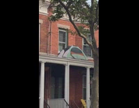 A tent perched up on porch ceiling