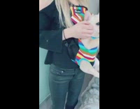 Girl carries puppy in rainbow backpack carrier 