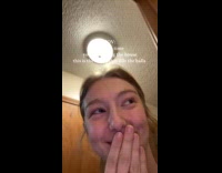 Woman giggling hearing husband and kid playing