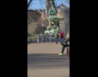 Dance group films video in front of fountain 
