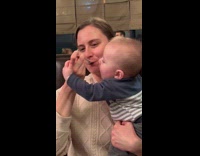 Baby pulling moms arms wants chocolate cake 