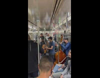 Group of musicians perform music on subway traiin