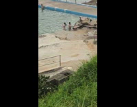 Two women bikini titkok dance poolside beach rocks