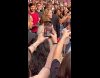 Crowd cheers for Miley Cyrus at festival