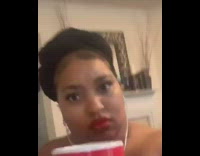 Girl holds red mug cup dances earphones 