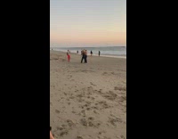 Two guys denim overalls straw hat beach