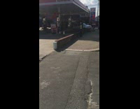 Silver car crashes brick wall gas station 