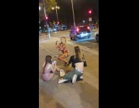 Woman in dress adjusts and flexes her butt