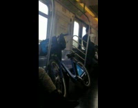 Man with blue citi bike smokes cigarette on subway train