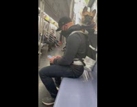 Guy on subway carrying bulldog in backpack