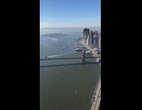 Contractor on top of very tall building in New York City, standing at edge, NYC skyline