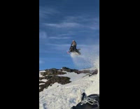 Guy jumps across mountain on snowmobile 