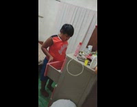 Chubby kid touches clothes pink cabinet shocked