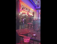 girl dances on table pizza bar