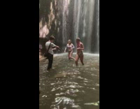 Girls under ground waterfall picture