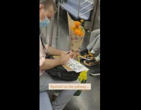 Man drawing on subway holding flowers