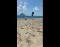 Girl attempts headstand on beach sand fail 
