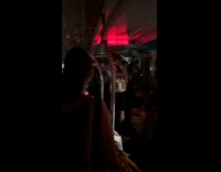 Filmer inside subway train with lights off