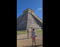 Two girls belly dance Aztec pyramid behind