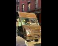 UPS truck drives with ticket on windshield