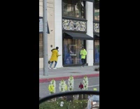 Guy walks down sidewalk for photo