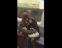Guy face mask embraces hugs lady subway 