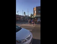 Woman and photographer umbrella move away street