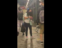 People watch as burst pipe rushes water onto subway platform