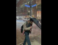 People cross street while raining pay parasol