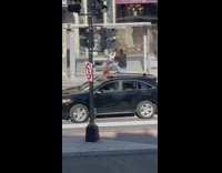 Model Poses on Street Bench Next to Intersection 