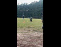 Two kids practice football hug each other